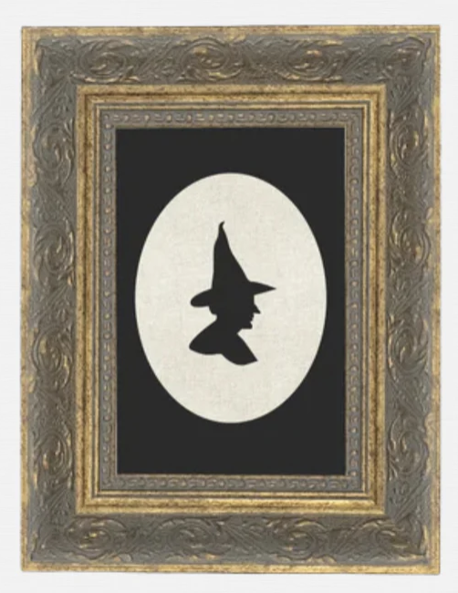 Silhouette of a witch in frame. Halloween wall decor.