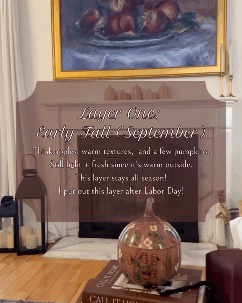 Cozy living room with a fireplace decorated for early fall. Subtle pumpkins, apples, and warm textures create a light and fresh seasonal look. Text overlay introduces Layer One: Early Fall (September).