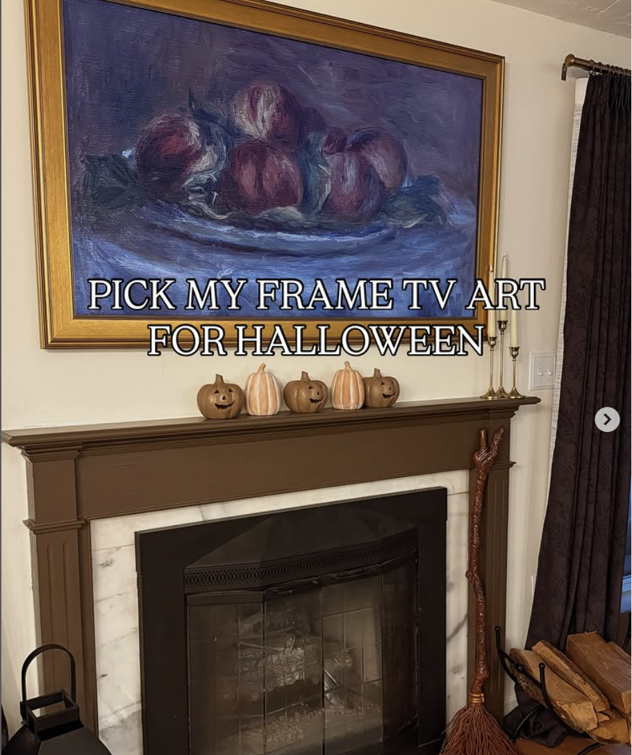 Samsung Frame TV styled with a moody still life art print for Halloween, displayed above a brown mantel decorated with mini pumpkin jack-o-lanterns and fall decor.