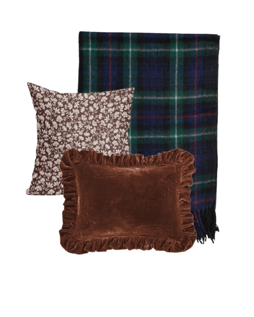A cozy fall throw and pillow combination featuring a burgundy floral pillow, brown velvet ruffle pillow, and navy plaid throw — timeless and elegant for autumn home styling.
