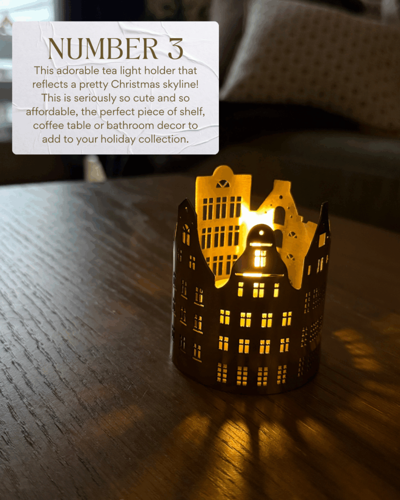 old metal tea light holder shaped like a charming European-style village, glowing on a wooden table. Creates a cozy holiday ambiance.