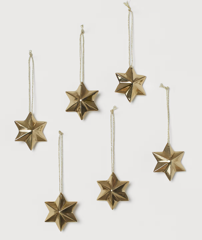 Set of six gold metal star ornaments from H&M Home with a faceted, three-dimensional design and gold string hangers — perfect for adding elegant shimmer to Christmas trees, garlands, and mantles. Christmas decor ornaments 