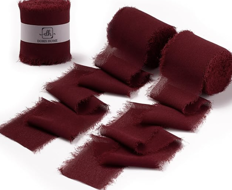 Burgundy velvet chiffon ribbon rolls with frayed edges, perfect for wrapping gifts, styling wreaths, or adding elegant texture to holiday garlands. A must-have for cozy Christmas decor and whimsical seasonal styling.