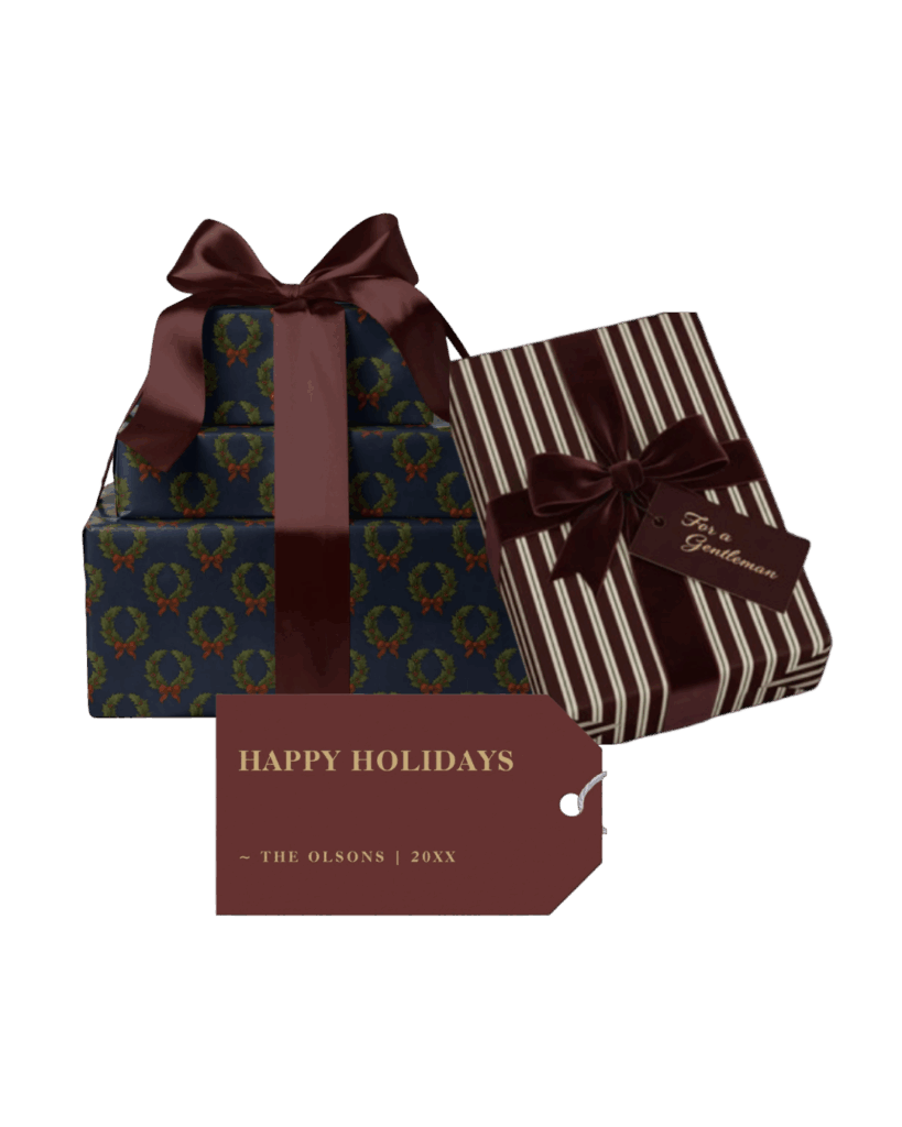Stack of navy gift boxes with wreath print and burgundy satin ribbons beside striped paper gift with matching tag.