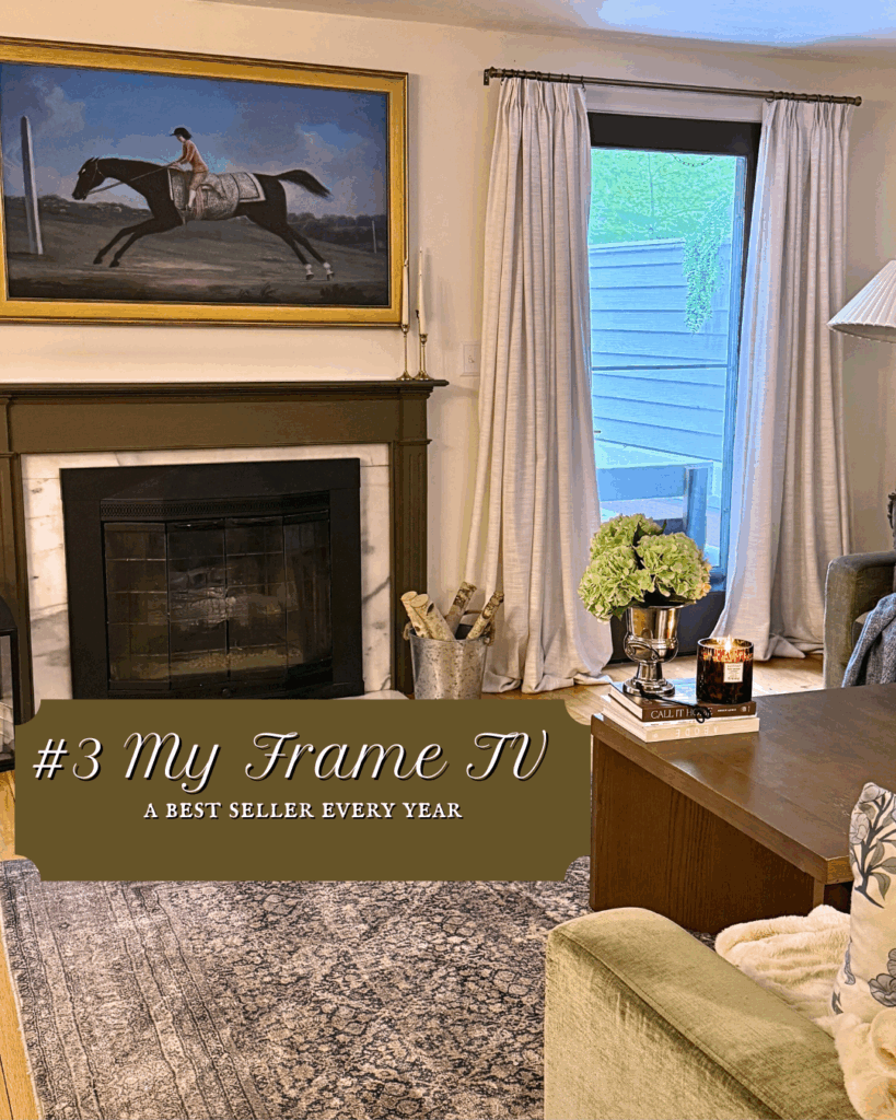 Samsung Frame TV styled above a fireplace in a traditional living room with neutral curtains, classic furniture, and layered decor.