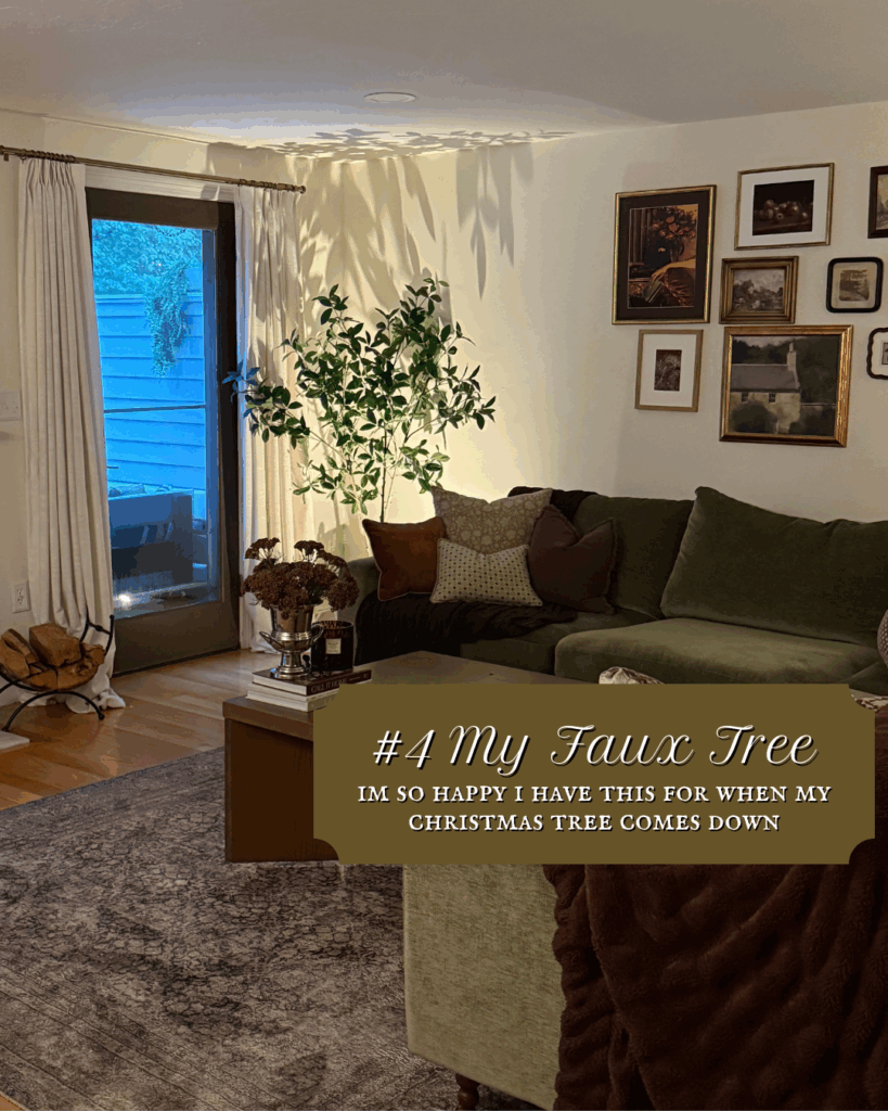 Cozy living room corner with a tall faux indoor tree next to a green sofa, gallery wall, and soft ambient lighting.