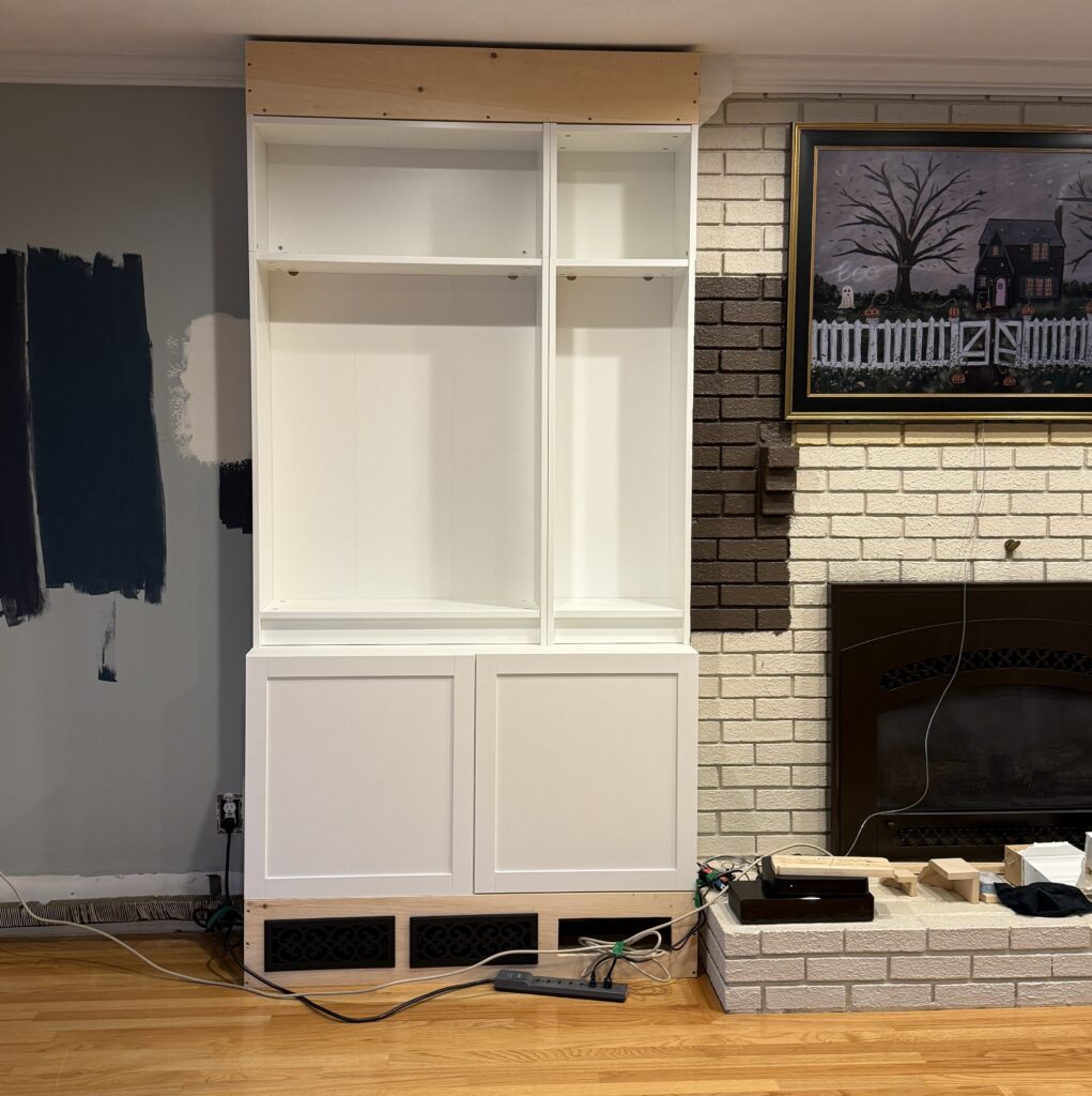 White cabinet under construction near fireplace