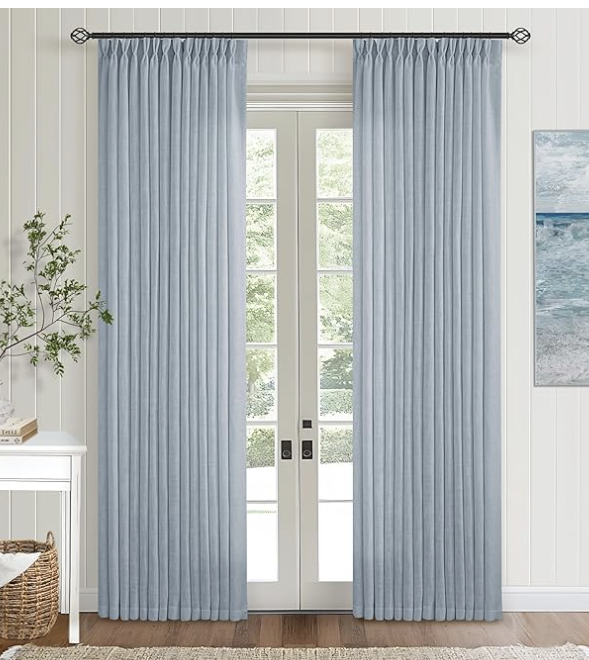Light blue curtains covering glass doors