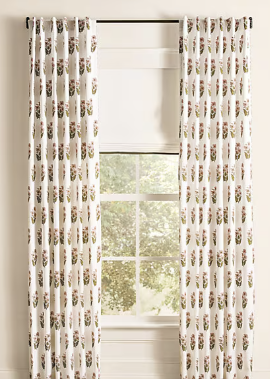 Floral patterned curtains by window