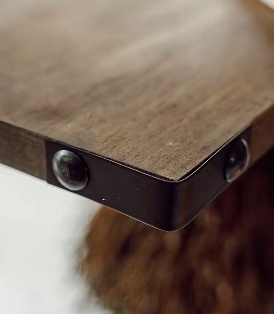 Metal corner detail on the wood shelves of a witch broom tiered tray