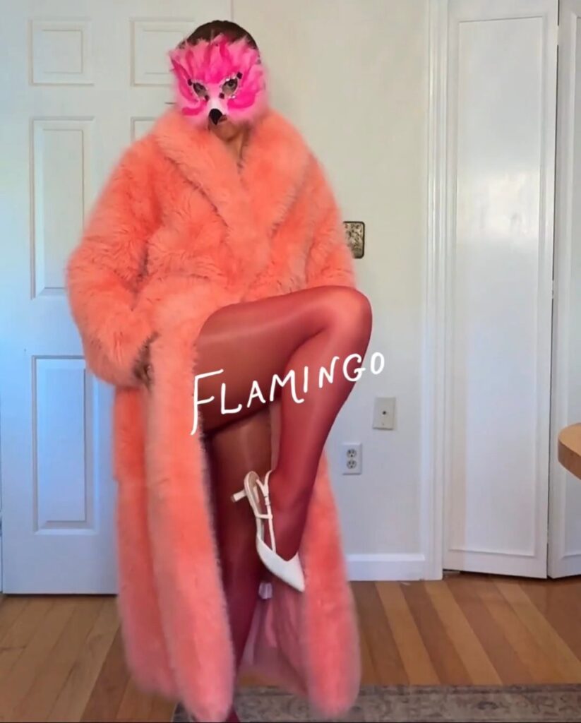 flamingo Halloween costume with a rented coral faux fur coat from Rent the Runway and a pink feather mask
