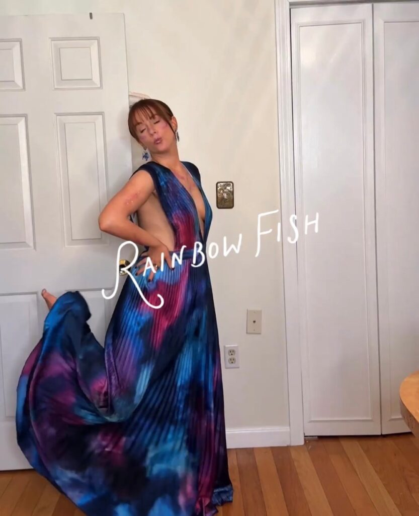 rainbow fish Halloween costume with a rented pleated satin gown from Rent the Runway, fish earrings and glitter